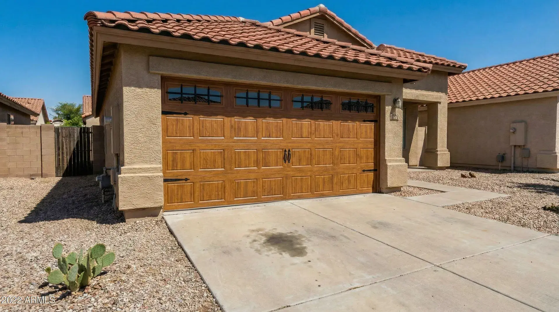 After: beautiful carriage-style garage door with decorative hardware