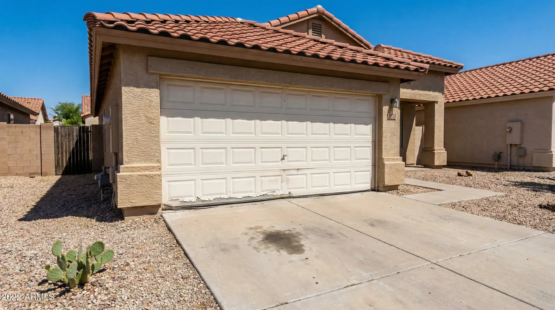 Before: sun-faded builder-grade garage door in Mesa