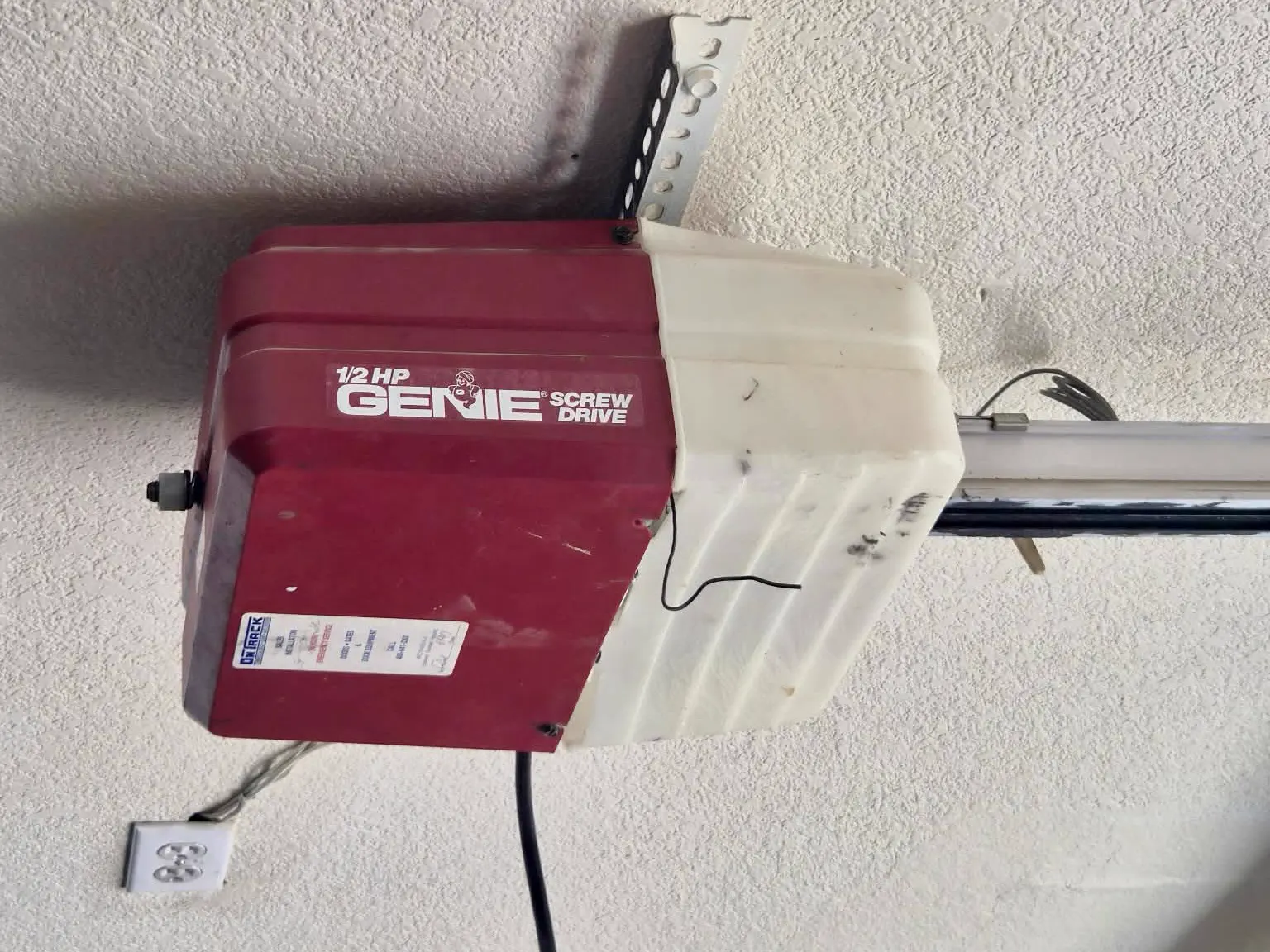 Before: dated half-horsepower screw-drive garage door opener with yellowed housing in Mesa