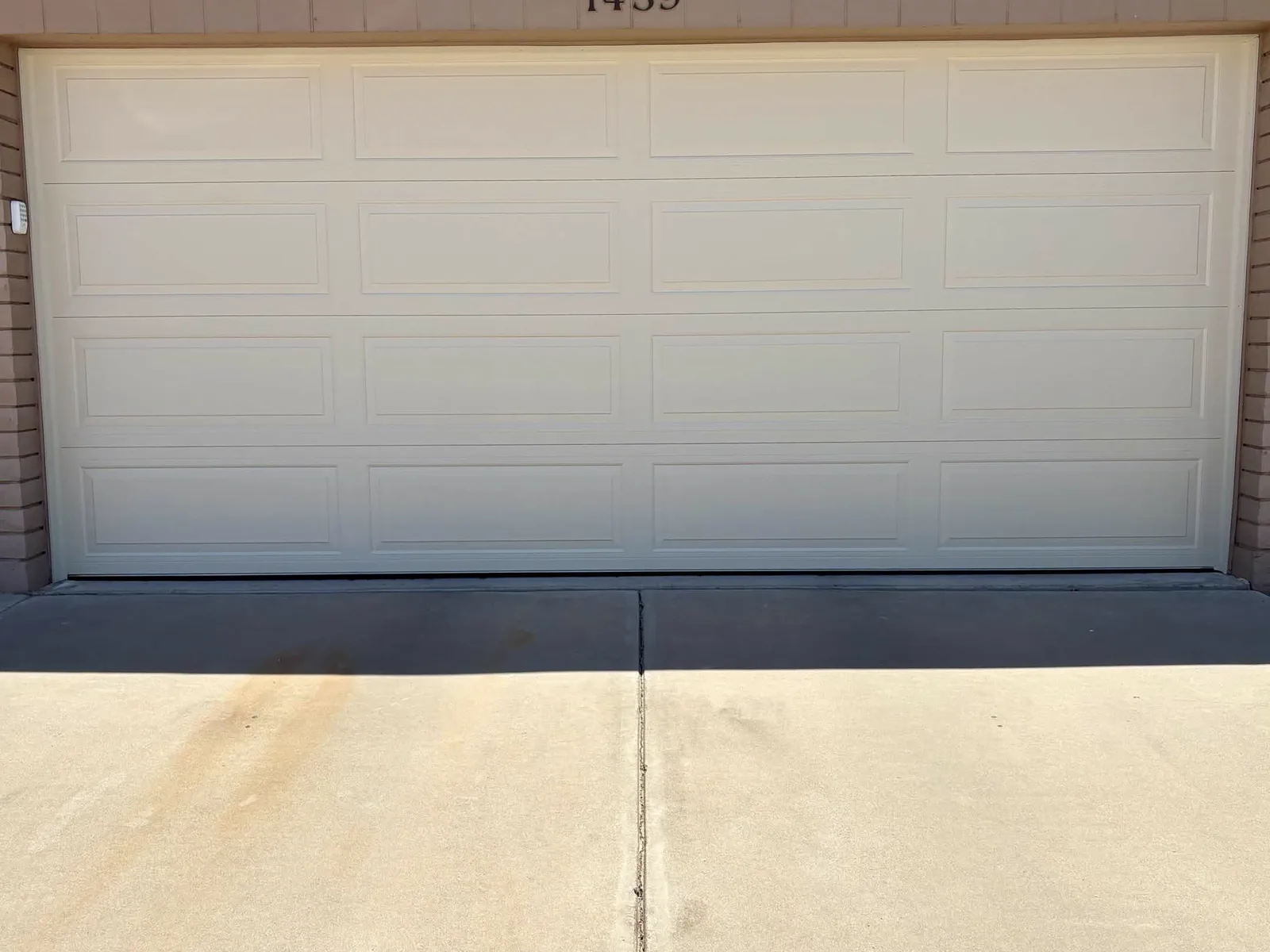 New steel-back insulated long-panel garage door after installation in Apache Junction, AZ