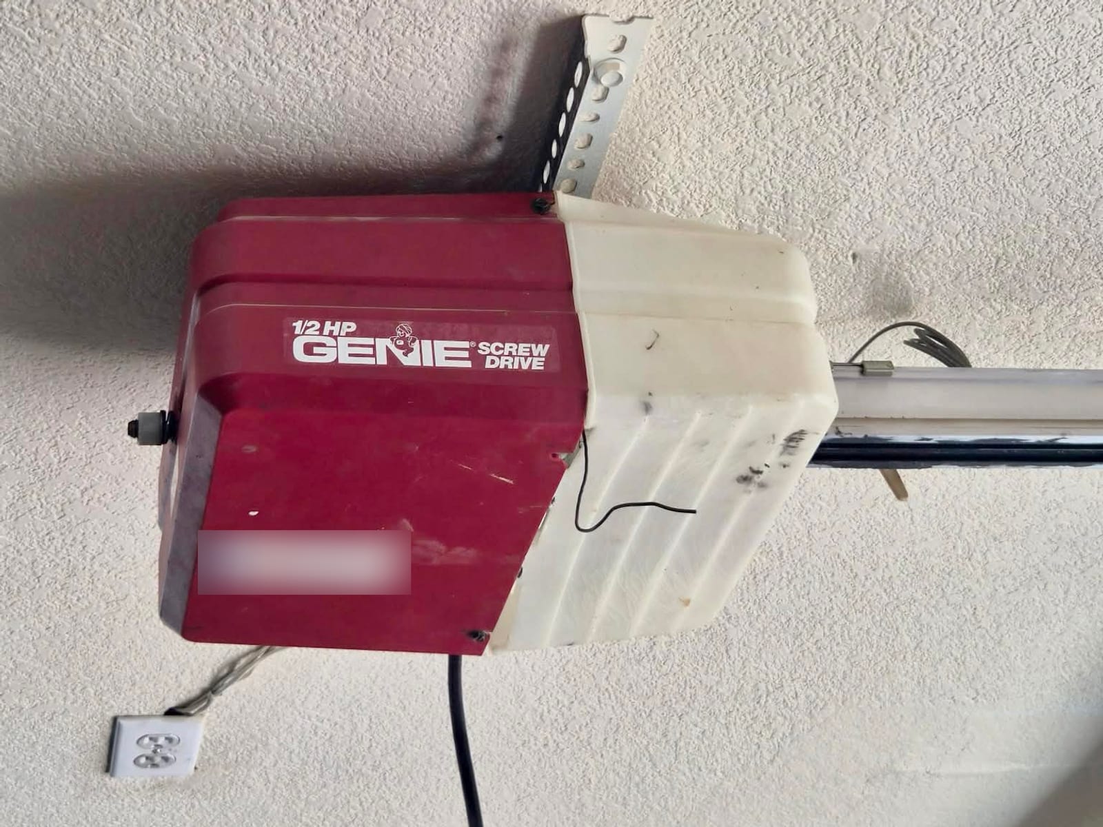 Before: dated half-horsepower screw-drive garage door opener with yellowed housing in Mesa